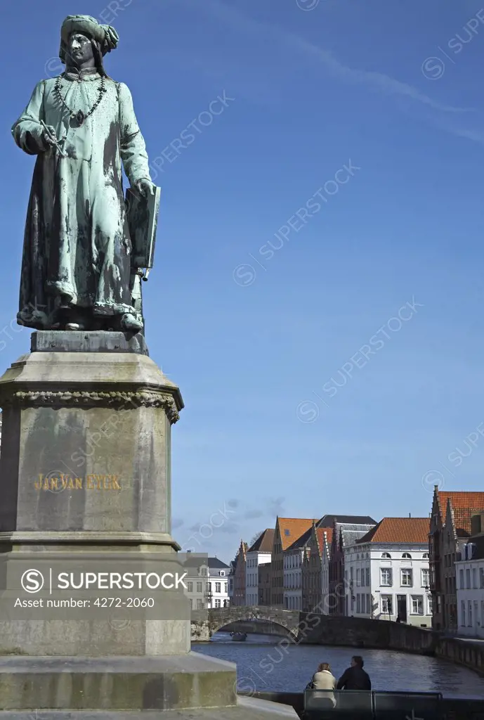 Belgium, Bruges. A statue of Jan Van Eyck (Flemish Northern Renaissance painter, 1395-1441) in front of one of the many canals.