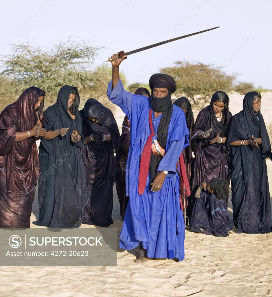 Mali, Timbuktu. A group of Tuareg men and women sing and dance near their desert home, north of Timbuktu.