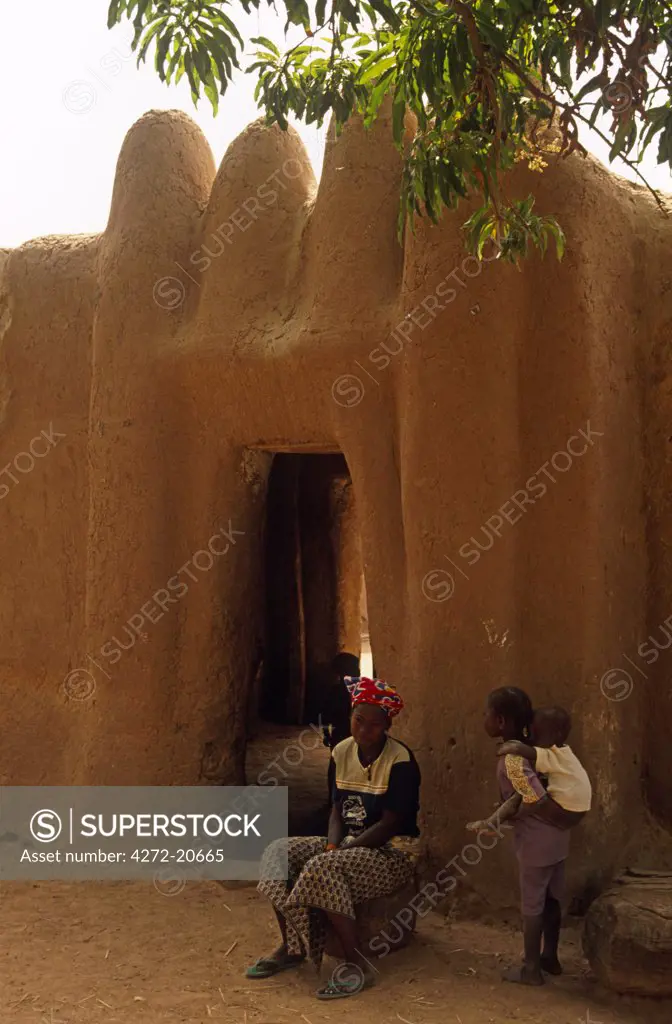 Mali, near Segou. Children outside the gateway of their mud brick home.