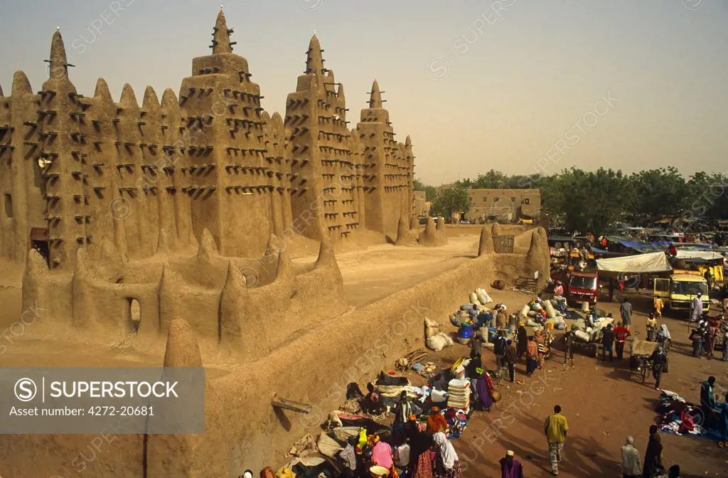 Mali, Djenne. Market stalls cluster beside the celebrated Mosque of Djenne, or Grande Mosquee, one of Africa's most striking mud brick buildings.