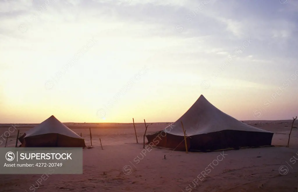 Traditional tents in the desert at nightfall. These tents serve as roadside motels, and can be rented out should the coast road become impassable. The coast road, Le Banc D'Aguin, is so close to the North Atlantic Ocean it can sometimes get flooded making travel by car extremely difficult.