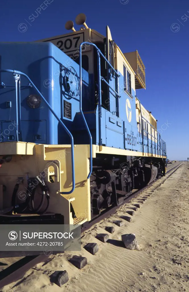 The locomotive for the worlds longest train sits at the station in Nou_dhibou. The full train is up to 2.5 kilometres long and trundles between Nou_dhibou and the iron mines of Zou_rat in Mauritania.