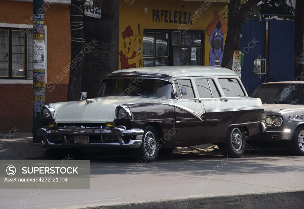 Mexico, Mexico City. A classic car parked in the north of Mexico City.