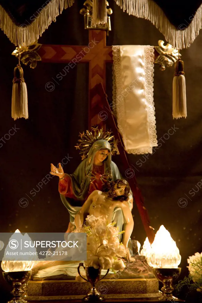 Europe, Malta, Qormi; The Pieta' as displayed in a statuette in a house window decorated for Holy Week at the village of Gharghur