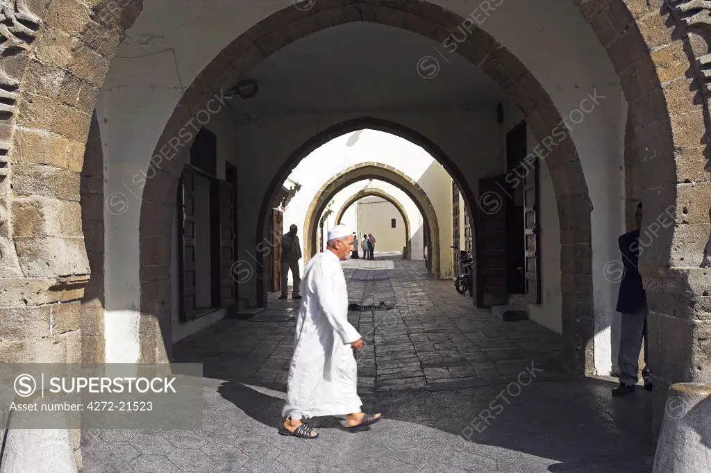 A moroccan man walks through the Quartier Habous or New Medina in Casablanca. Built by the French in the 1930s, the architects tried to marry the best of traditional moroccan design with modern techniques and facilities. The result is an idealised but attractive version of a traditional Moroccan medina.