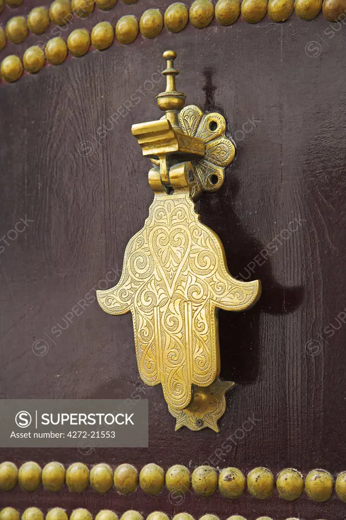 The Hand of Fatima on a traditional wooden door in the kasbah of Tangier, the highest point in the city. The hand protects the house from the evil eye.