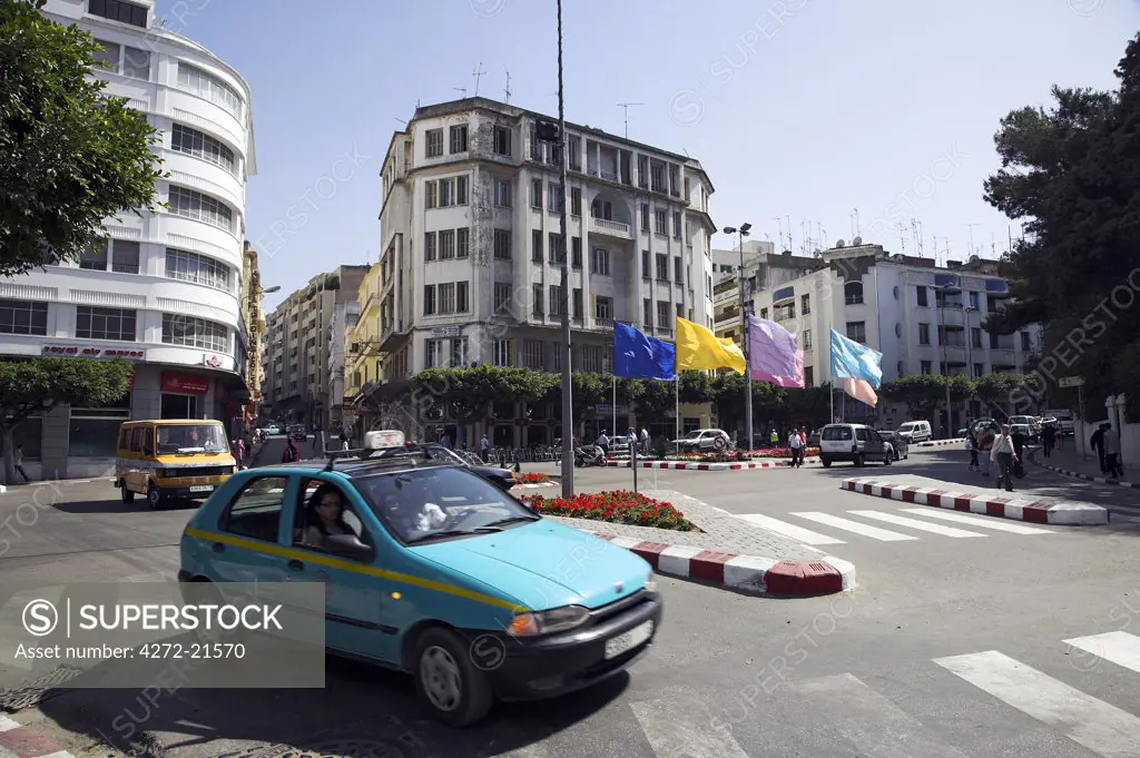 Taxis race through the Place de France in the centre of the Ville Nouvelle, Tangier.