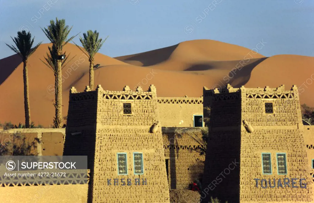 MOROCCO, Merzouga A desert kasbah backing onto the giant sand dunes of Erg Chebbi in eastern Morocco.