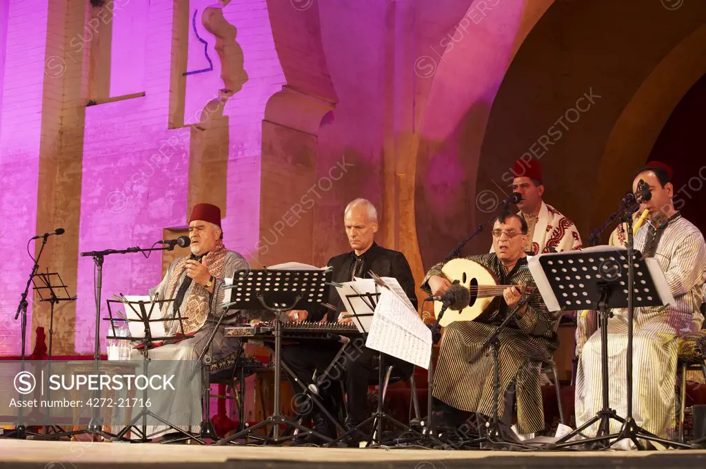 Morocco, Fes. Jalledine Julien Weiss and his Al Kindi Ensemble, with Sheikh Hamza Shakour perform on the Bab Makina stage during the Fes Festival of World Sacred Music.