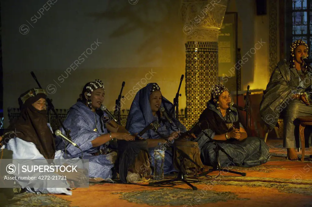 Morocco, Fes. Members of the Tarti Women's Ensemble from Mali (5 women and 4 men) play their traditional Tinde drums in the Dar Tazi during the Fes Festival of World Sacred Music.
