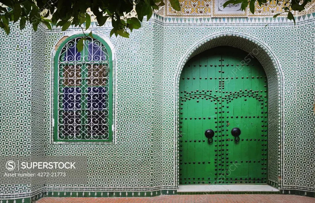 Green facade inside the Chefchaouen medina. Morocco