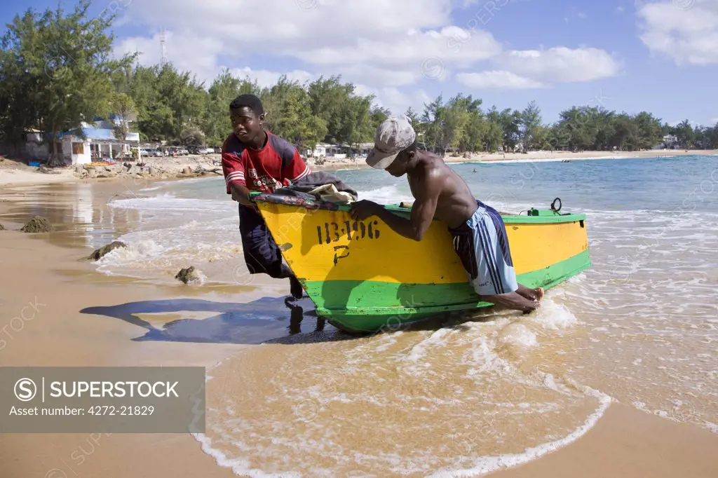 Fishermen haul their boat up onto the beach at Tofo, near Inhambane in southern Mozambique.