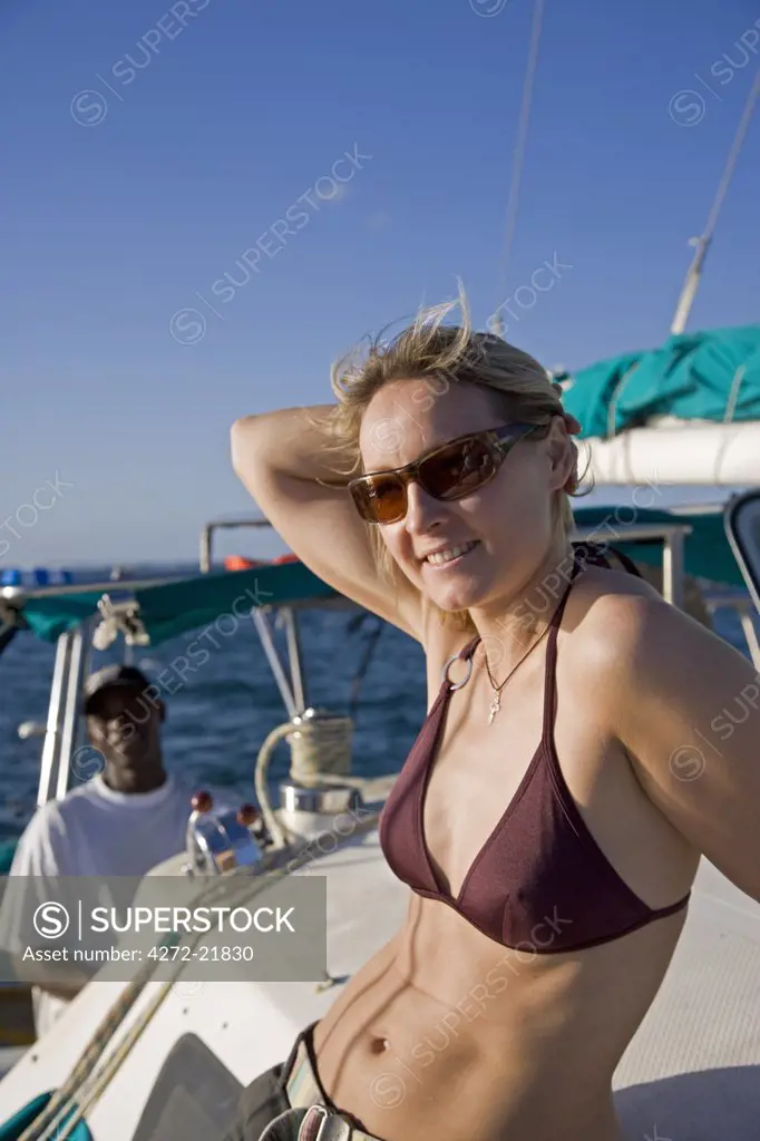 A young woman relaxes on a catamaran off Barra beach near Inhambane in southern Mozambique.