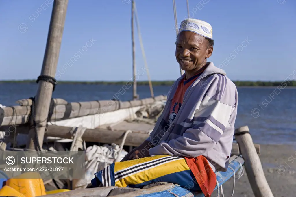 A dhow captain waits for high tide in the harbour of Ibo Island, part of the Quirimbas Archipelago, Mozambique