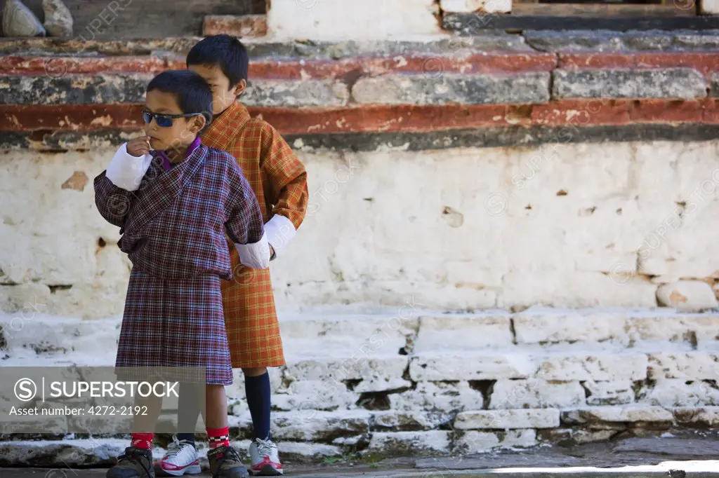 Bhutan. Children playing around the grounds of the tsechu in Wangdue Phodrang .