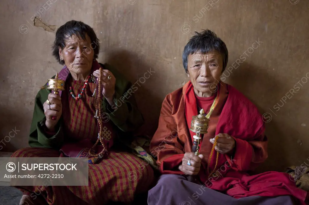 Bhutan. Devout Bhuddist worshippers with prayer wheels at the Gantey Gompa in Bhutan. Gangteng Monastery.
