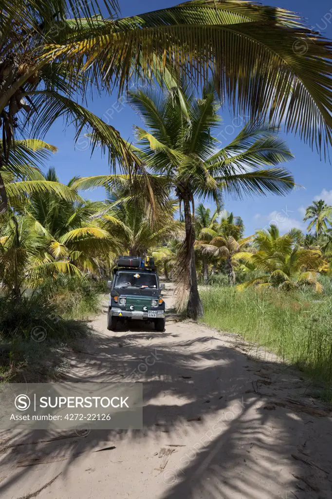 Mozambique, Tofo. A 4x4 explores the back roads by the beaches of Tofo.