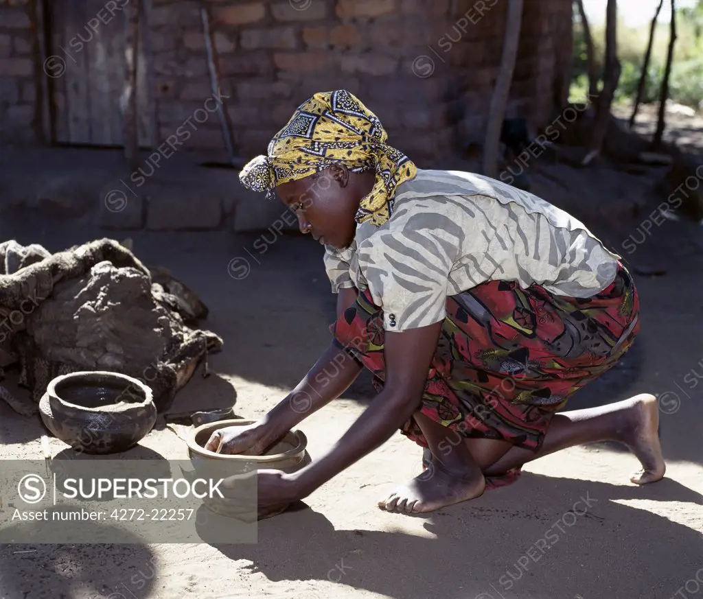 A girl makes clay pots near Liwonde.
