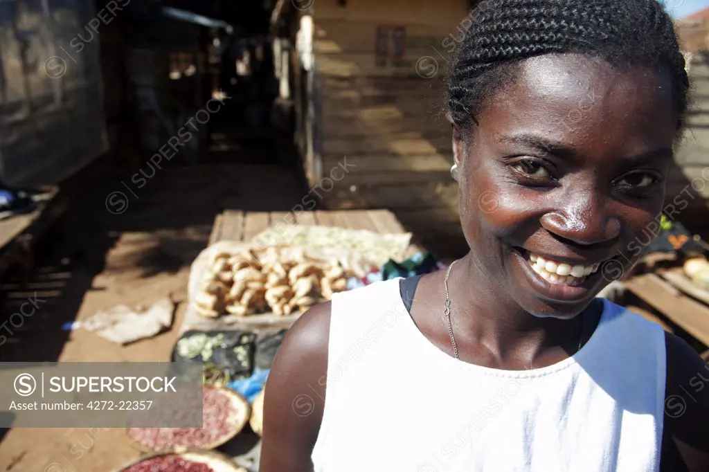 Malawi, Zomba. In the covered market area of the former capital, a young woman tends her vegetation stall.