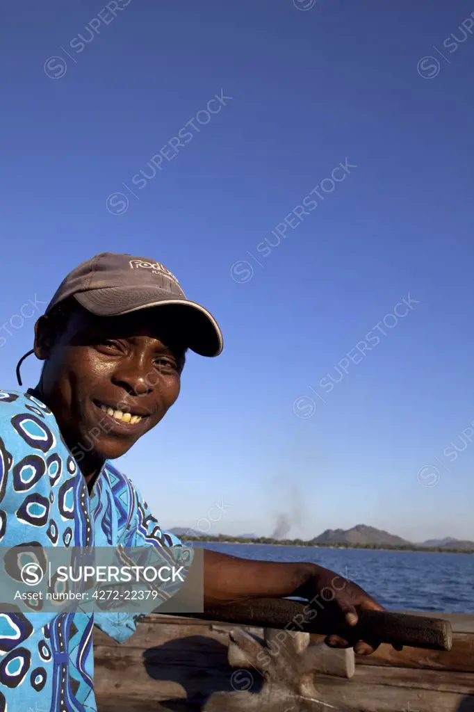 Malawi, Lake Malawi, Nkwichi Lodge. A boatman crosses the Mozambican side of Lake Malawi to reach the lodge.