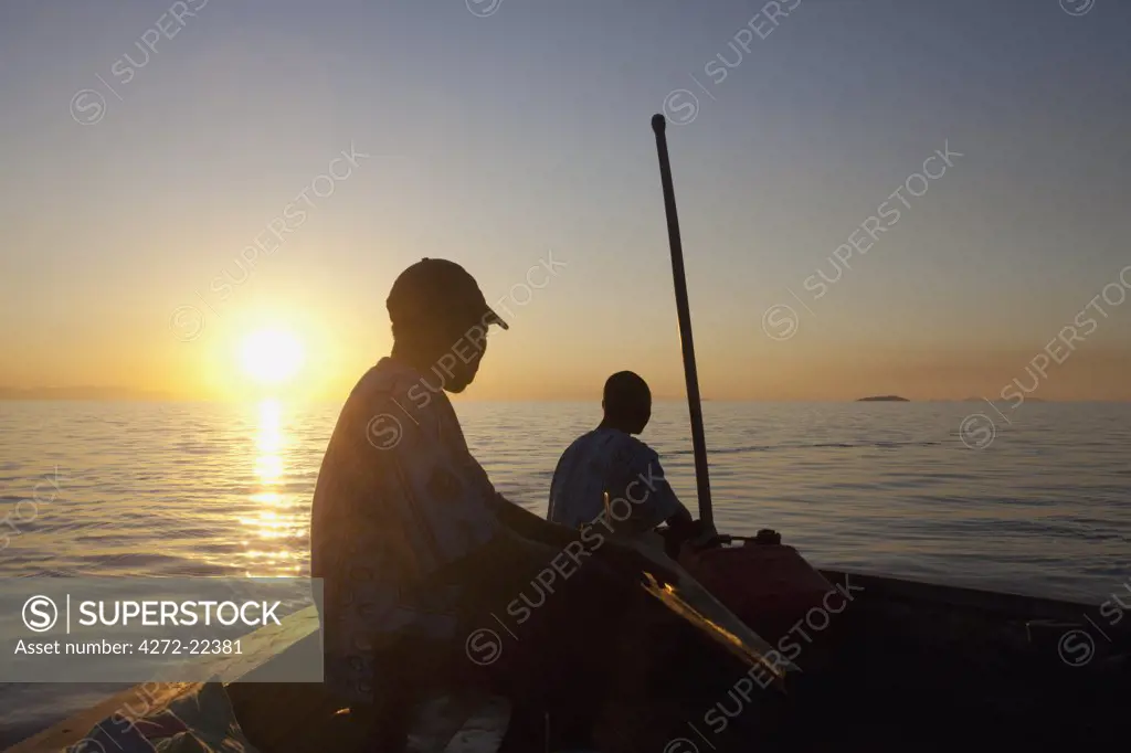 Malawi, Lake Malawi, Robin Popes Pumulani Lodge. A dhow sails across the placid waters of Lake Malawi.