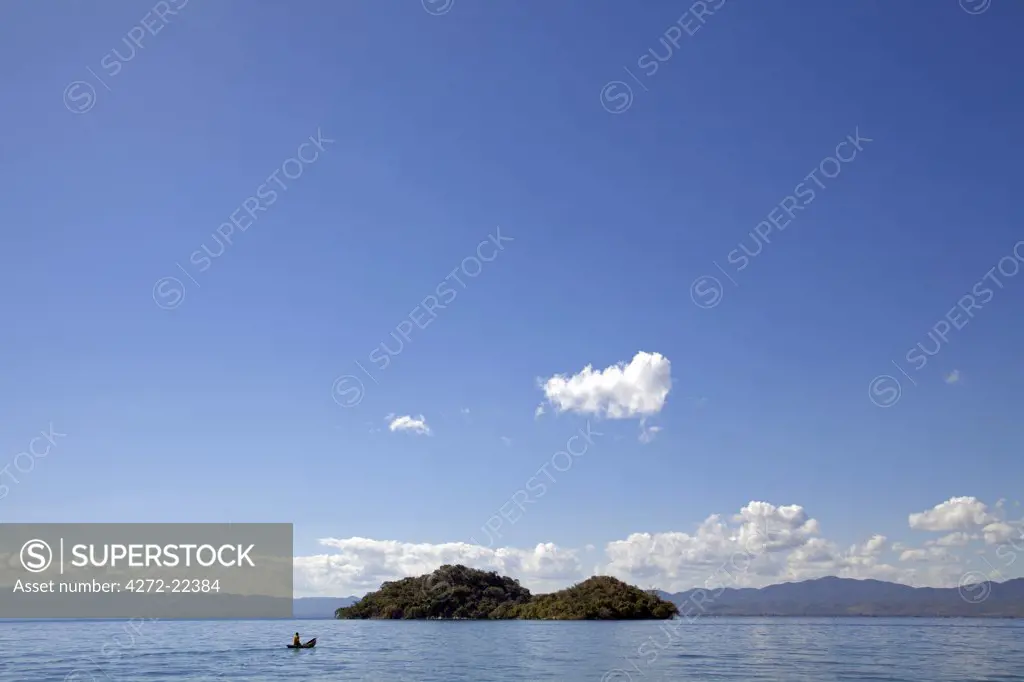Malawi, Lake Malawi. Fishermen in traditional wooden dhows enjoy warm sun and calm waters.