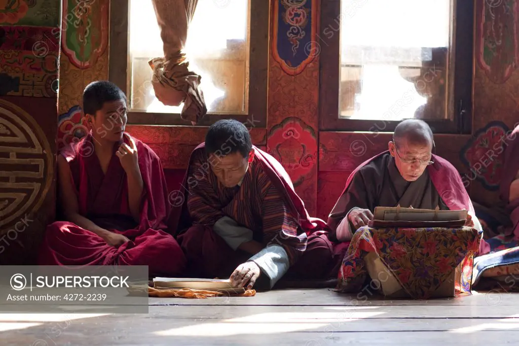 Monks at the sacred thread ceremony for the deceased in the monestery un Ura, Bumthang, Bhutan