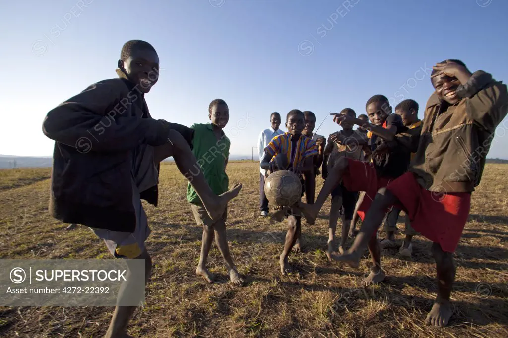 Malawi, Lilongwe, Ntchisi Forest Reserve. The local young football team show off their ball control skills