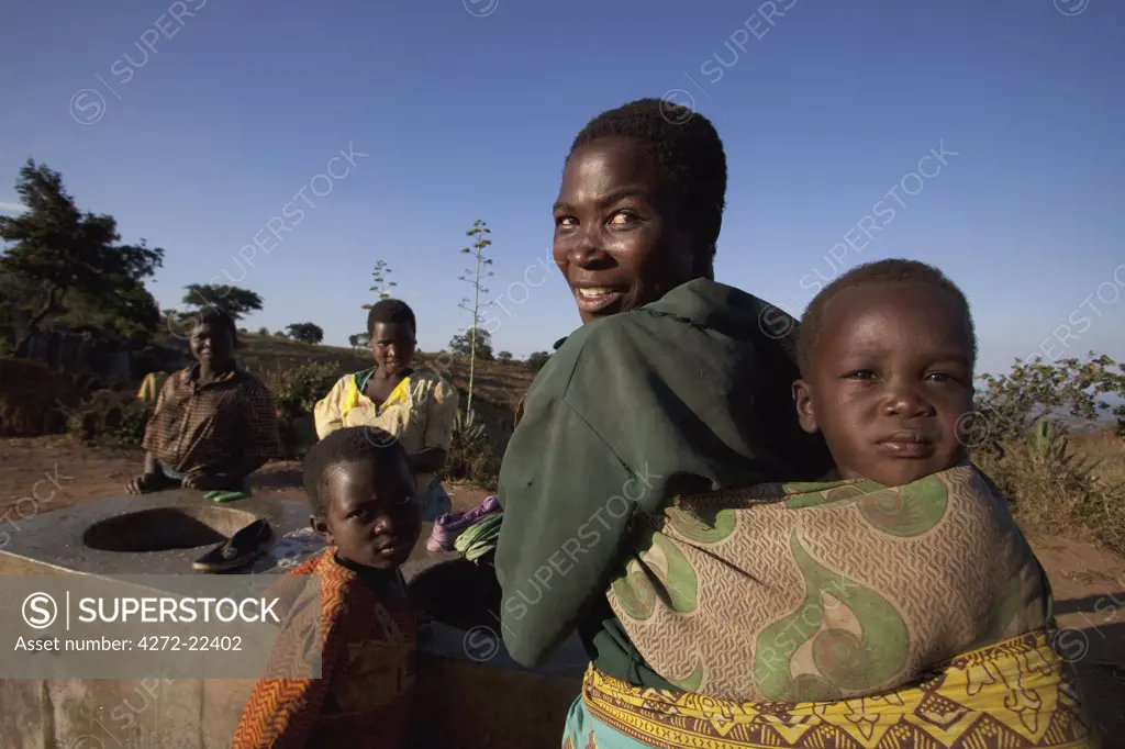 Malawi, Lilongwe, Ntchisi Forest Reserve. Woman from a nearby village gather at the communal washing and water point