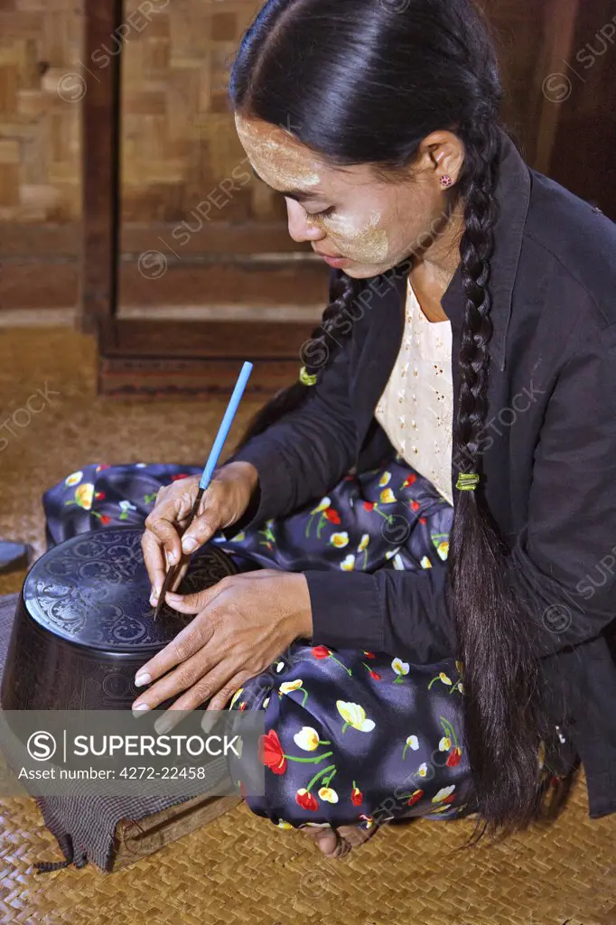 Myanmar. Burma. Bagan. A Burmese woman engraving a lacquer bowl at a lacquer workshop in Bagan.