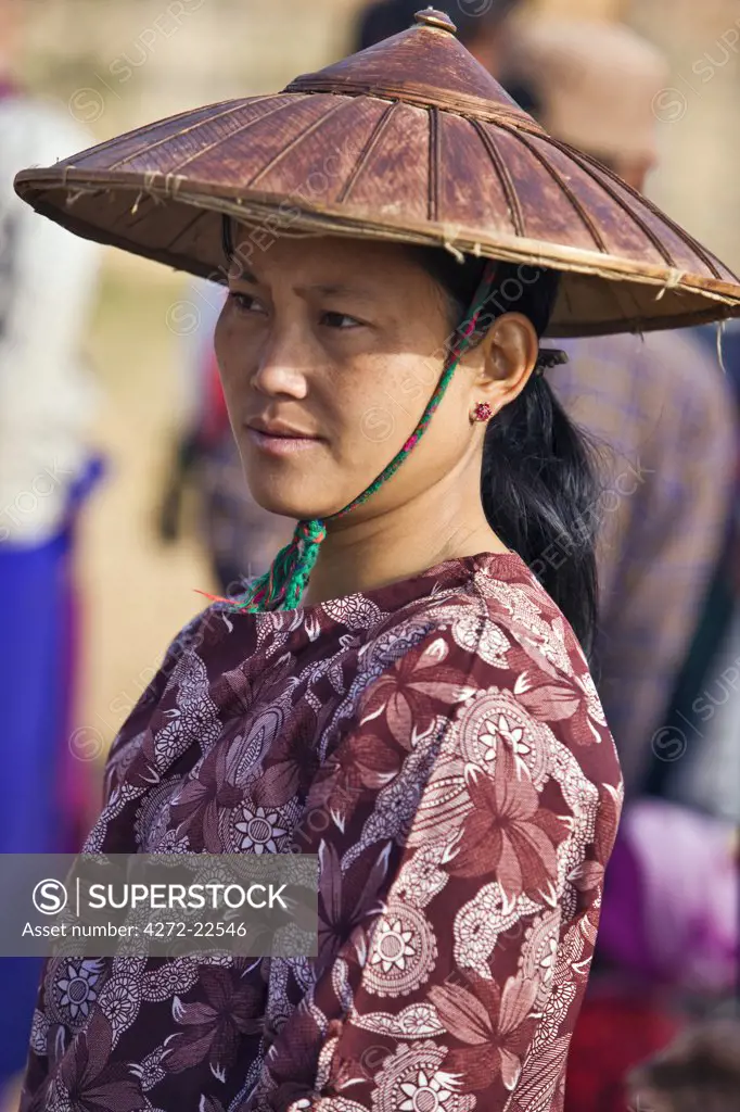 Myanmar, Burma, Lake Inle. A woman wearing a traditional wide-brimmed bamboo hat at Indein market.