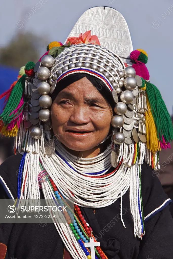Myanmar, Burma, Kengtung. An Akha woman wearing a traditional headdress of silver and beads.