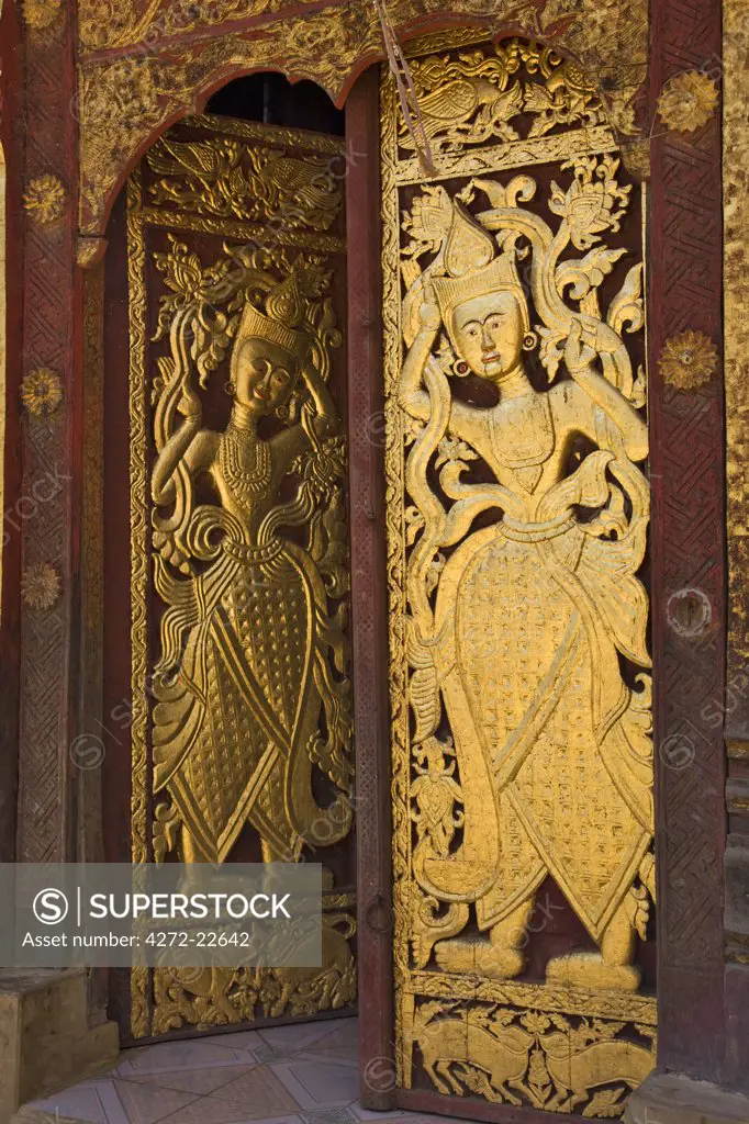 Myanmar, Burma, Wan-seeing. The ornately carved and gilded doors of the beautiful 15th or 16th century Wan-seeing monastery.