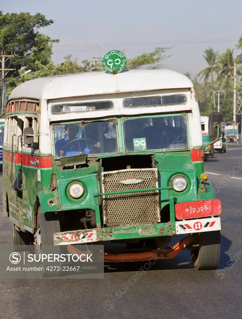 Myanmar, Burma, Yangon. A pre-war bus, sometimes known as an iron turtle, plying the streets of Yangon.