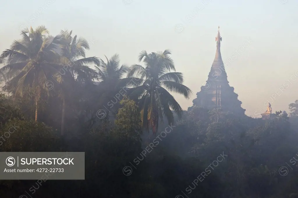 Myanmar, Burma, Mrauk U. Early morning mist shrouds an historic temple of Mrauk U which was built in the Rakhine style between the 15th and 17th centuries.