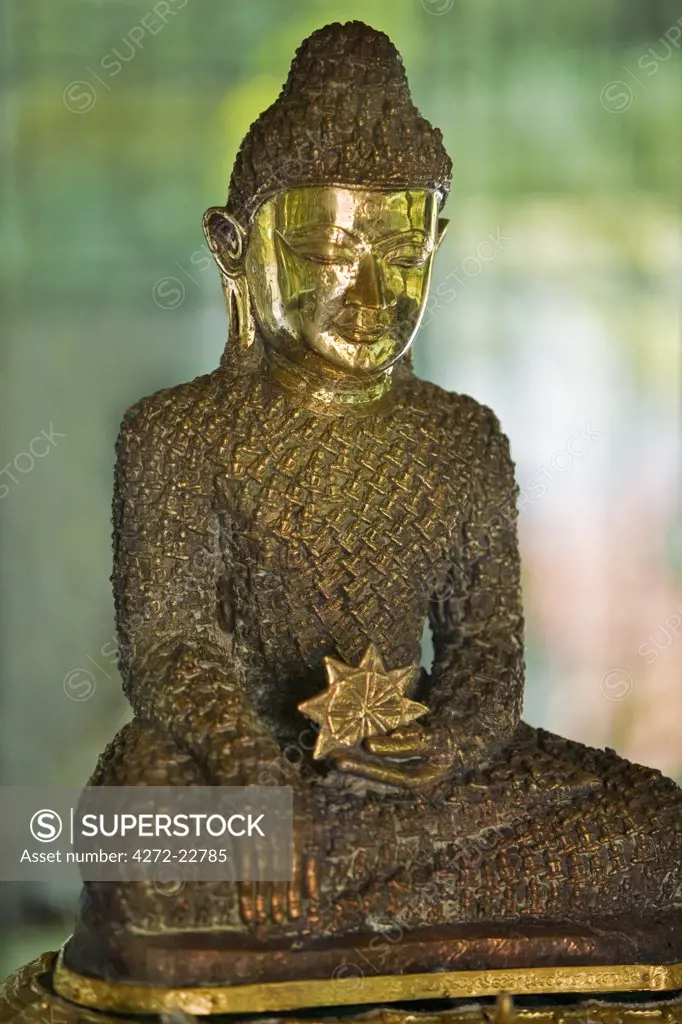 Myanmar, Burma, Rakhine State, Sittwe. The 18-inch-high Bronze Buddha at Lawkanandar Pagoda is claimed to be 2,000 years old.  It has clothing made up of 1,162 small Budhha images.