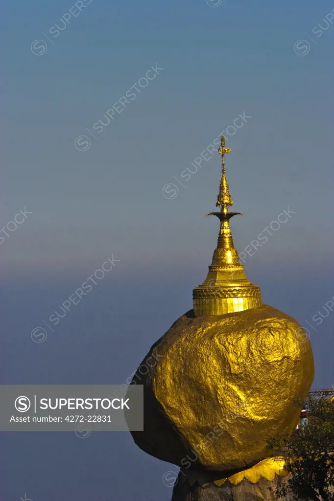 Myanmar, Burma, Golden Rock, Kyaiktiyo. The Golden Rock boulder balanced precariously on the edge of Mount Kyaiktiyo.