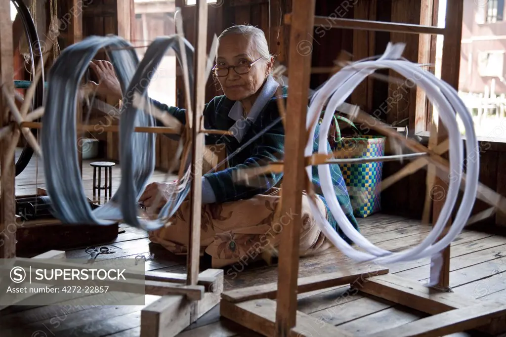 Myanmar, Burma, Inle Lake.  Spinning silk in a weaving factory, Inle Lake.