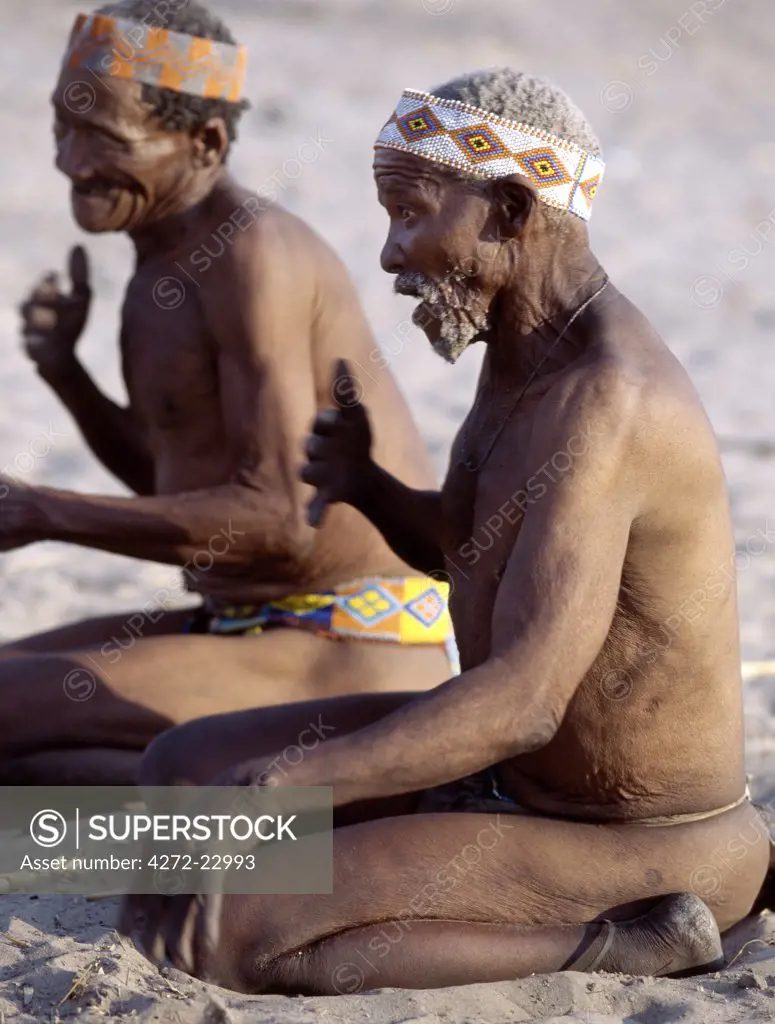 Two Kung elders enjoy a lively, competitive game in which the oldest generation of a hunting band pits its skills against a younger generation.  The Kung live in the harsh environment of a vast expanse of flat sand and bush scrub country straddling the Namibia Botswana border.