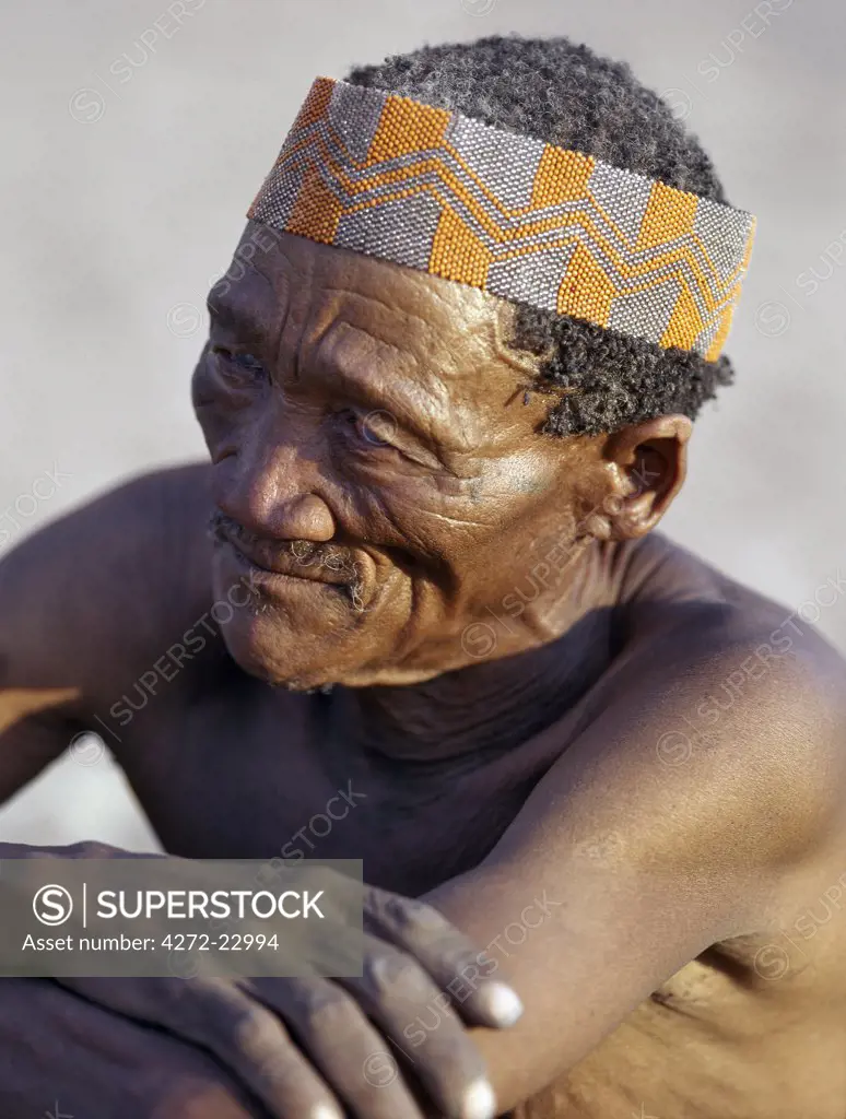 An old Kung man. The Kung are San hunter gatherers, often referred to as Bushmen.The Kung live in the harsh environment of a vast expanse of flat sand and bush scrub country straddling the Namibia Botswana border.