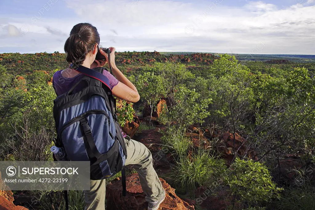 A hiker pauses to take a photograph atop the Waterberg Plateau in central Namibia.