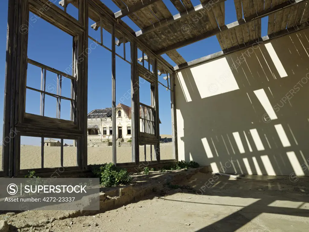 A scene in the deserted diamond-mining town of Kolmanskop, which was abandoned more than fifty years ago.  The place is now a ghost town where sand from the surrounding desert has encroached into all the old buildings of this once prosperous place.