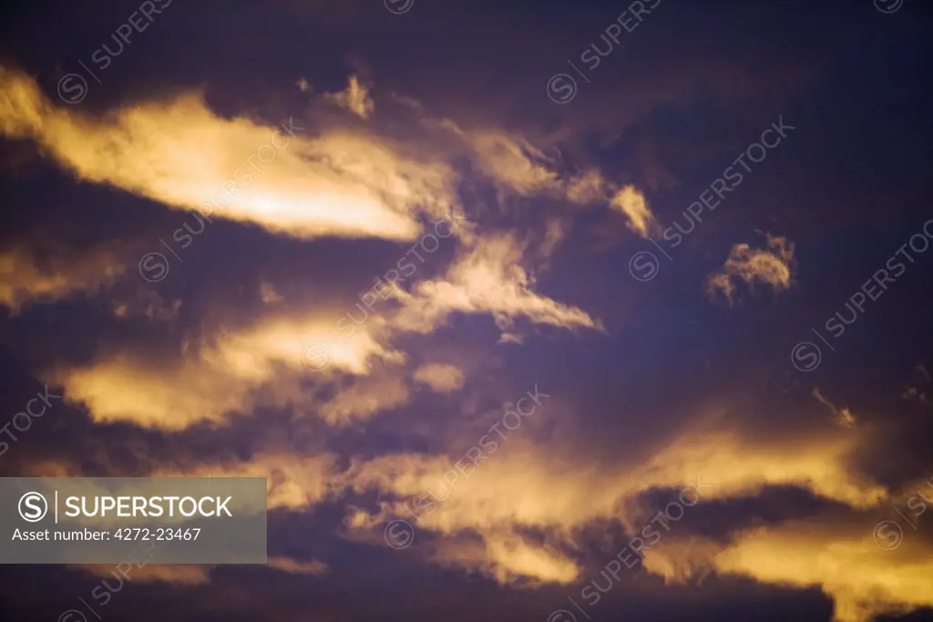 Africa, Namibia, Erongo Mountains.  Sunset over the Erongo Mountains near Omaruru in Central Namibia during the wet season with the edge of storn creating dramatic cloud formations.