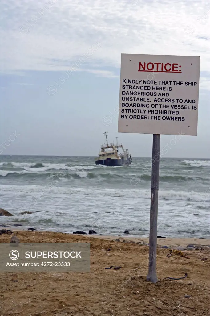 Namibia, Erongo Region, Swakopmund. The Skeleton Coast is stark and inhospitable - the coast's most recent shipwreck is a fishing trawler cast aground just outside of Swakopmund with a warning sign against boarding her.