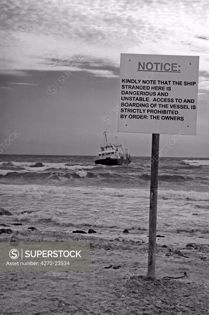 Africa, Namibia, Swakopmund. The Skeleton Coast is stark and inhospitable, the coast's most recent shipwreck is a fishing trawler cast aground just outside of Swakopmund with a warning sign against boarding her.