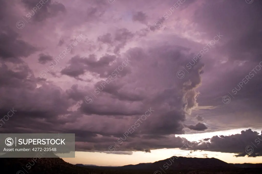 Namibia, Damaraland. Dramatic cloud build up over the table top mountains viewed from the Vingerklip Lodge in northern Namibia.