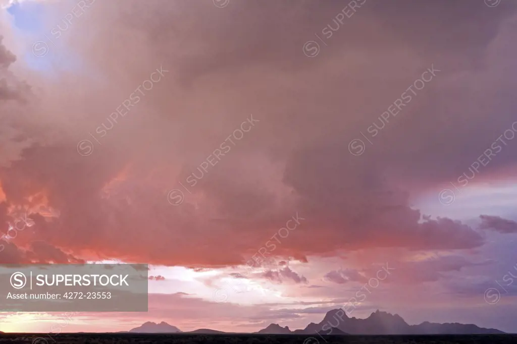 Namibia, Damaraland. Incredible light during stormy weather over Spitzkopje Mountain the 'Matterhorn of Africa' at sunset.