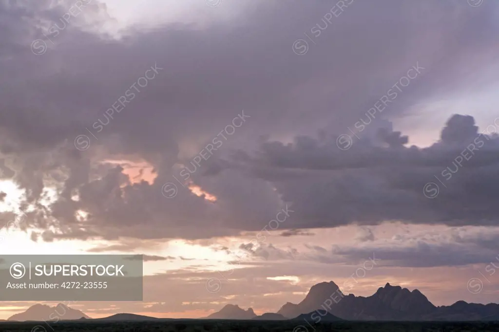Namibia, Damaraland. Incredible light during stormy weather over Spitzkopje Mountain the 'Matterhorn of Africa' at sunset.