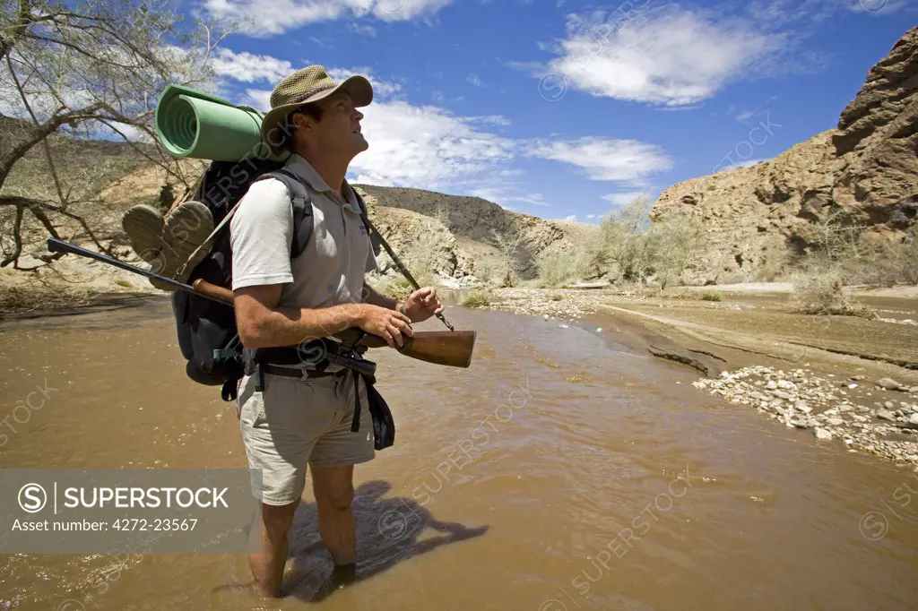 Namibia, Namib Naukluft National Park. The Kuiseb Canyon forms the southern edge of Namib Desert Park. The river flows only occasionally and does not reach the sea. Ex-Game Ranger - Kobus Alberts - armed with a rifle against hyena attack was, with photographer Mark Hannaford, the first person to explore its length.