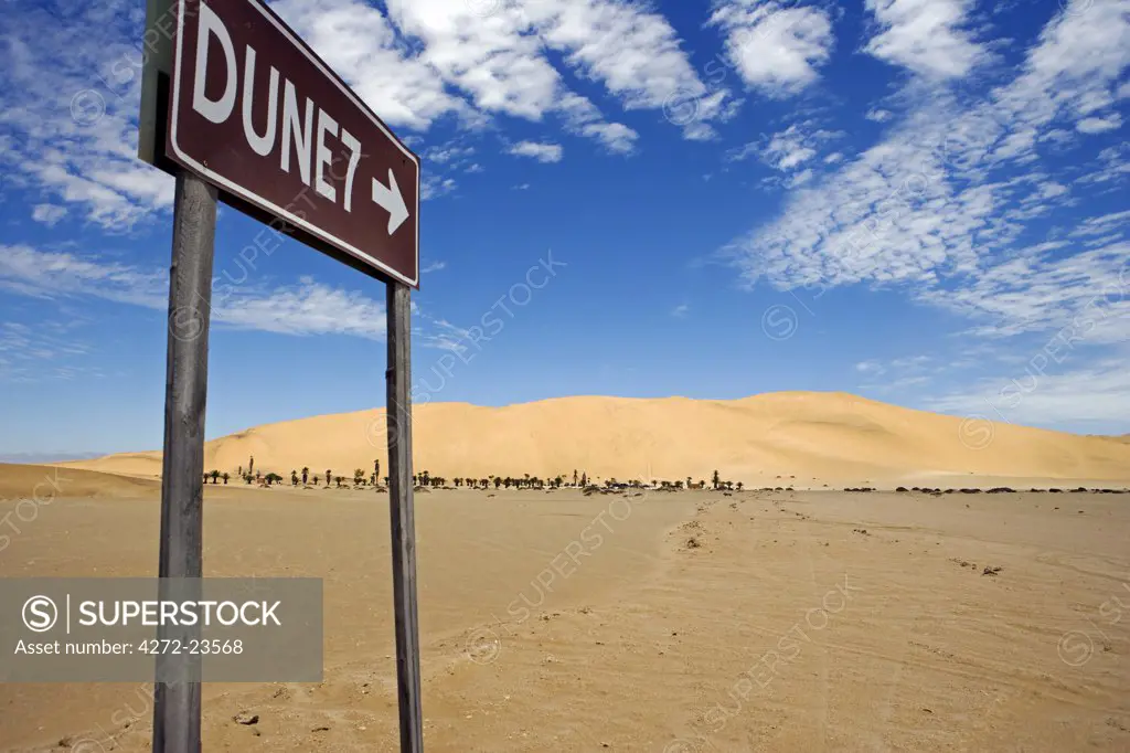 Namibia, Skeleton Coast, Walvis Bay. The sign to the popular tourist dune of Dune 7 located near to Walvis Bay and Swakopmund. Dune 7 is a large sand dune in the Namib Desert, one of the largest in the world and the highest in the coastal belt popular with sandboarders.